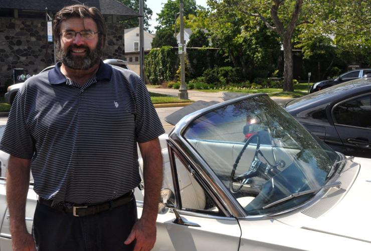Patrick Hurst, owner of American Classic Rides, stands next to a 1963 Chevy Impala