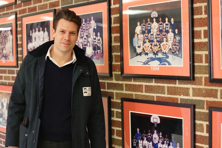 Josh Glessing in front of photos