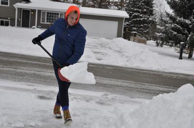 Jordan Lauer shoveling snow