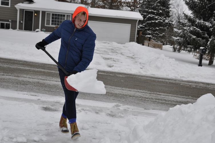 Jordan Lauer shoveling snow