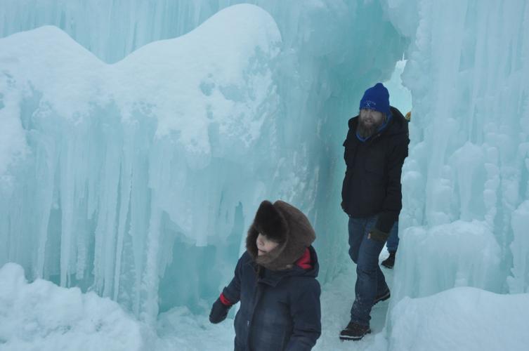 Spectators walk through the maze of the ice castle structure.