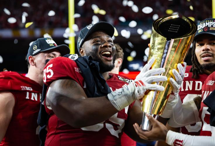 Jan 19, 2026; Miami Gardens, FL, USA; Indiana Hoosiers defensive lineman Tyrique Tucker (95) celebrates with the trophy after defeating the Miami Hurricanes in the College Football Playoff National Championship game at Hard Rock Stadium. Mandatory Credit: