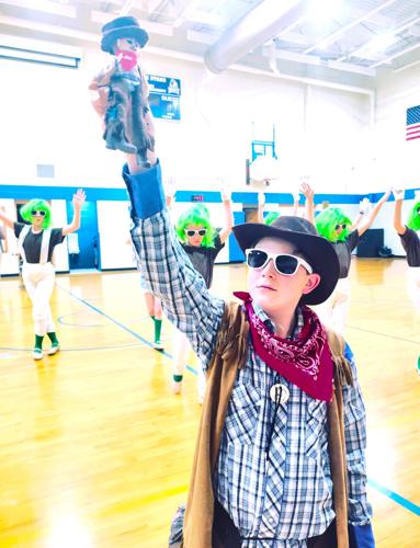 Mike Teavee and the Oompa-Loompas in the April 21-22, 2023 Reek Elementary School production of "Willy Wonka Jr."
