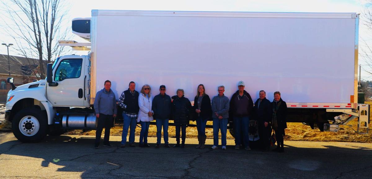 Representatives from the Walworth County Food & Diaper Bank stand in front of the refrigerated box truck that they recently received from the Hunger Task Force