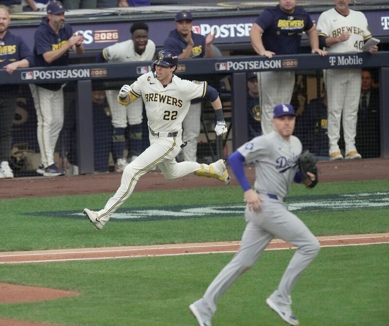 Milwaukee Brewers designated hitter Christian Yelich (22) runs to first after hitting an RBI single during the third inning of their National League Championship Series game against the Los Angeles Dodgers at American Family Field on Oct 12, 2026.