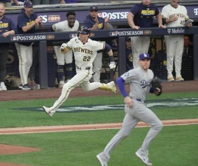 Milwaukee Brewers designated hitter Christian Yelich (22) runs to first after hitting an RBI single during the third inning of their National League Championship Series game against the Los Angeles Dodgers at American Family Field on Oct 12, 2026.