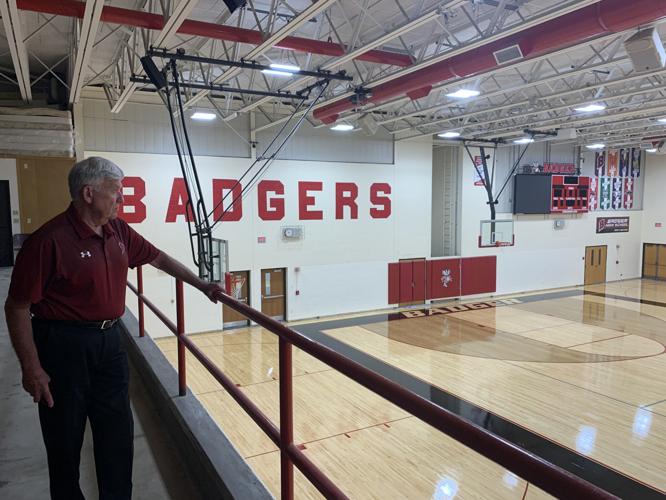 Superintendent James Gottinger looks over the new gymnasium floor that recently was installed at Badger High School