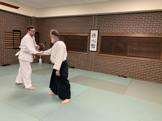 Students Seth Klosinksi and Bruce Kyes prepare to work on some aikido techniques