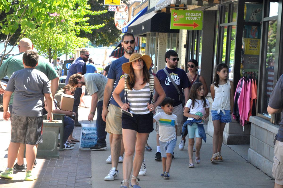 People crowd city sidewalks during a recent weekend, as more people have been visting the