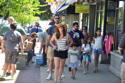 People crowd city sidewalks during a recent weekend, as more people have been visting the