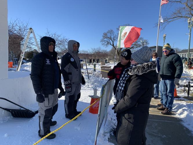 Members of Team Mexico discuss their sculpture with Winterfest spectators