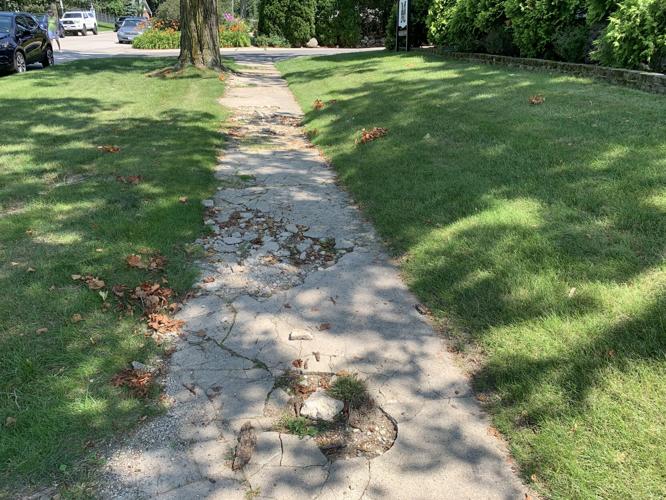 Some city officials feel the sidewalk on the south side of Baker Street should be repaired first before a sidewalk connection is installed on the north side of the street