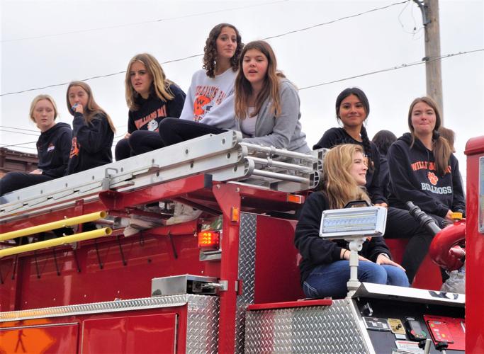 Williams Bay High School's volleyball teams ride atop a fire truck in the school's 2022 homecoming parade