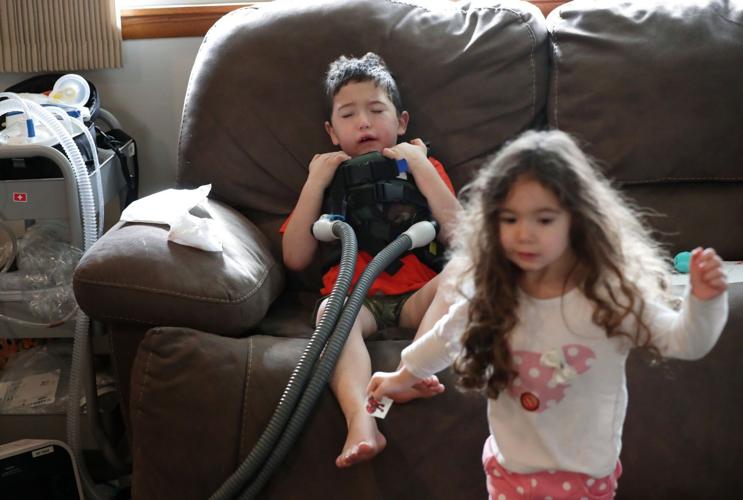 Javier with breathing vest and Amelia