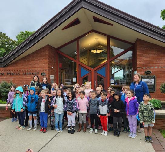 Central-Denison Elementary School students stand in front of the Lake Geneva Public Library after the ribbon-cutting ceremony