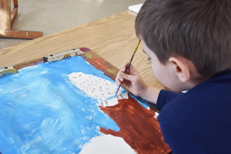 Luca Melendez works on details of owl painting during art class at Wustum museum