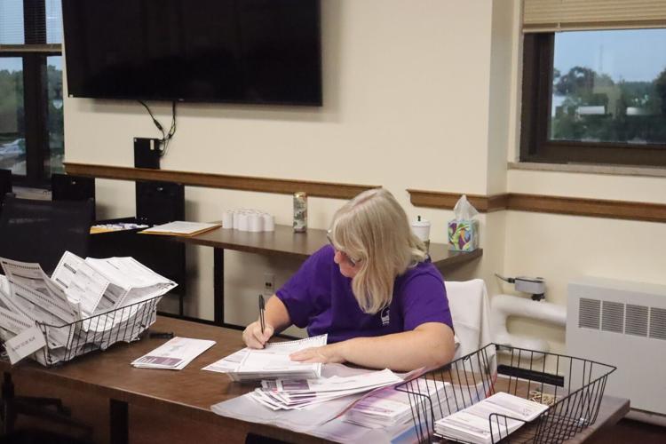 Lynn Landwehr processes absentee ballots