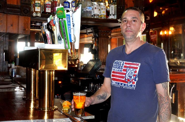 Dan Kuhl, Hogs & Kisses bartender, prepares to serve a customer