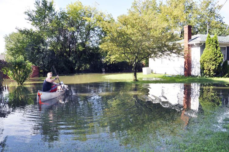 Dillan Schneider man in canoe flooding