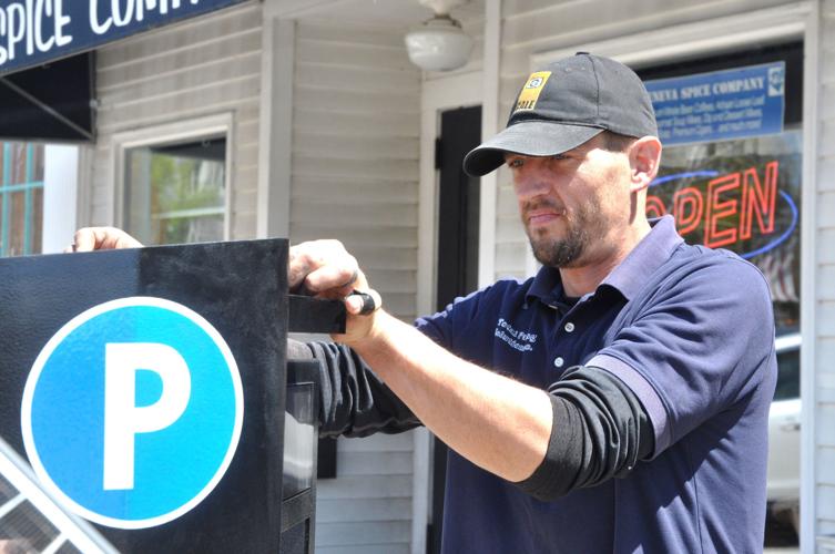 Nick Sondelski of Total Parking Solutions checks over a parking kiosk