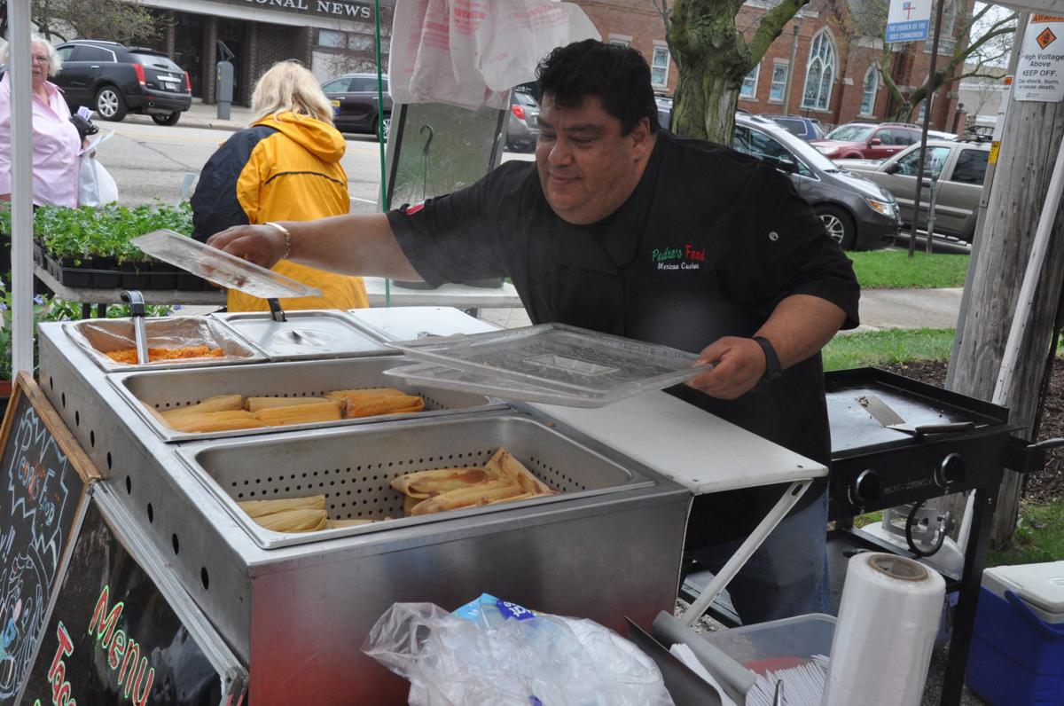 Pedro Nunez prepares tamales and other food items