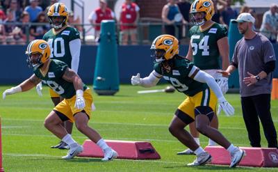 Green Bay Packers linebackers Isaiah McDuffie (58) and Ty'Ron Hopper (59) run through a drill during the second day of training