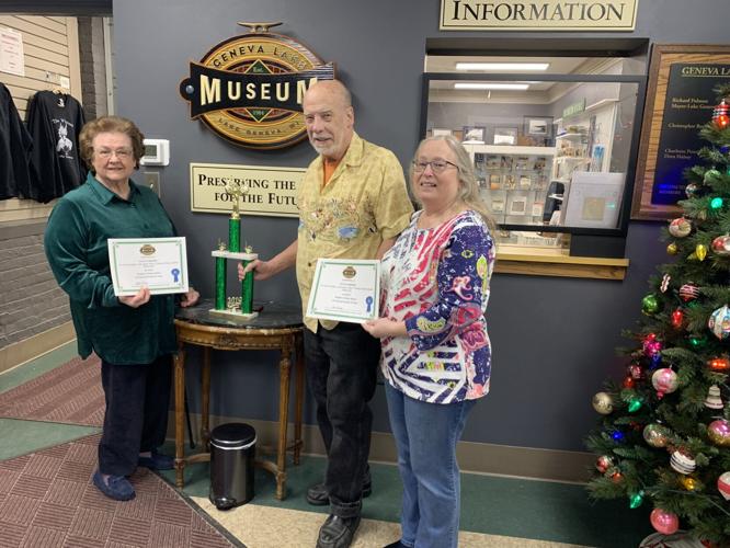 Members of the Pete's Printing team display their certificates and traveling trophy