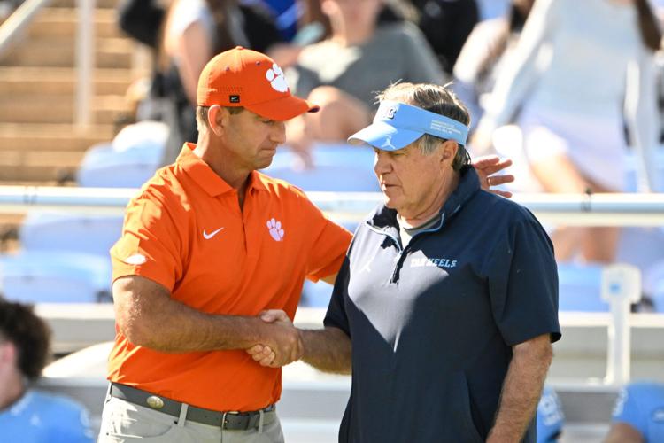 Oct 4, 2025; Chapel Hill, North Carolina, USA; Clemson Tigers head coach Dabo Swinney with North Carolina Tar Heels head coach Bill Belichick before the game at Kenan Stadium. Mandatory Credit: Bob Donnan-Imagn Images