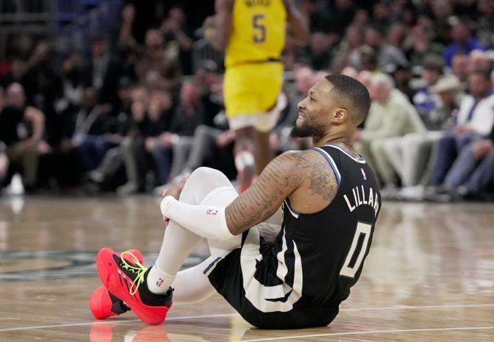 Milwaukee Bucks guard Damian Lillard sits on the court after suffering a non-contact injury during the first half of their playoff game against the Indiana Pacers.