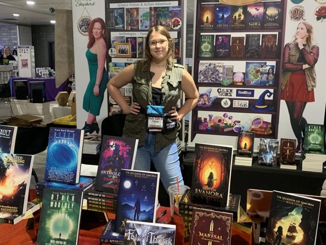 Tiffany Nickel, co-founder of Red Rose Works and author of the "Legends of Limoria" series sells a collection of books during EGG Con II