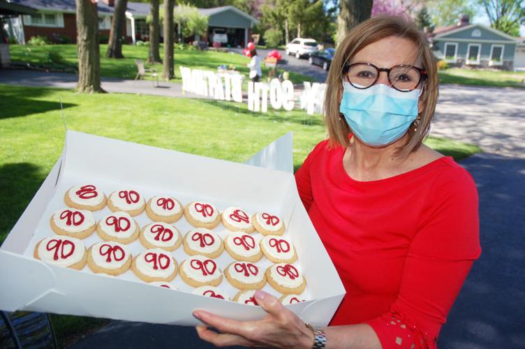 Daughter hands out cookies for Gene Haseley's birthday parade