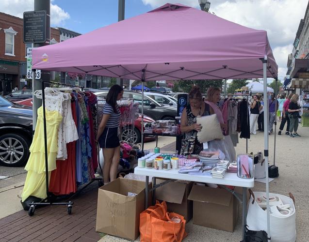 Maxwell Street Days customers look through items stationed outside of Pink Moon Bay, 717 W. Main St.