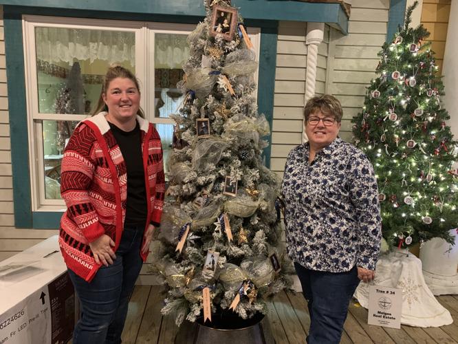 Monica Pfeifer and Wendy Hetzel of Maxwell Mansion stand next to their decorated Christmas tree