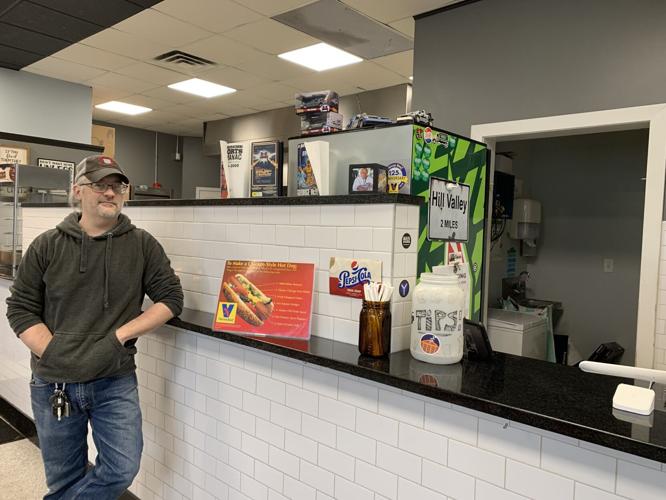 Frank Broz stands next to a counter at Clock Tower Pizza