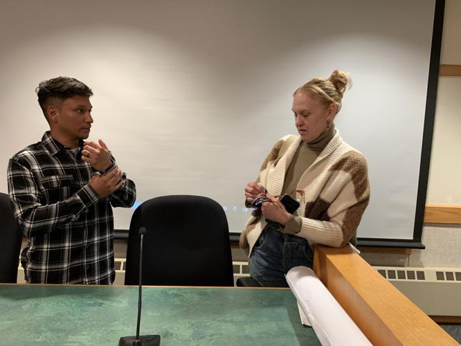 Harbormaster Erick Nicia shows off the new resident beach passes to Alderwoman Shari Straube