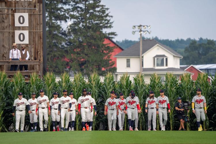 Players walk onto the field before a baseball game between the Minnesota Twins and the Philadelphia Phillies at the Field of