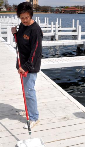 Harbormaster Linda Frame prepares to do some painting work on the west end pier