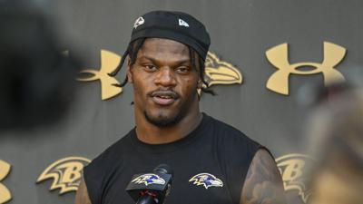 Ravens quarterback Lamar Jackson answers questions from the media after practice in September.