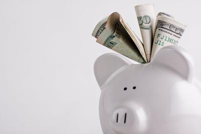 One stuffed, overfilled full piggy bank