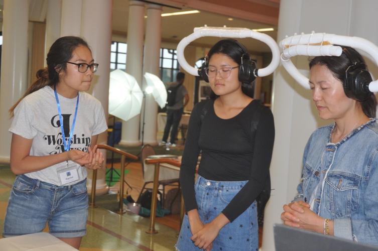 Rachel Lee, left, gets her sister, Diane Lee, and mother, Kyung Lee, to participate in a sound-related