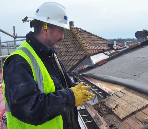 Adam Wolfe, senior project manager for MSI General inspects some of the damage that has