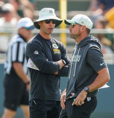 Packers defensive coordinator Jonathan Gannon talks with coach Matt LaFleur during practice Aug. 4.
