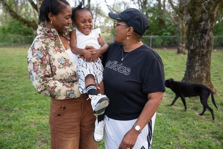 Kaylor Murray, holds her 2-year-old daughter, Kana-Leia Murray, while standing next to her mother, Kathryn Murray-Mays, while their dog, Cocoa, plays nearby at their home in Nashville on Tuesday, March 31, 2026.