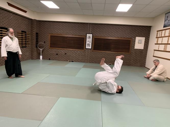 Student Seth Klosinksi practices some rolling techniques during his promotion testing