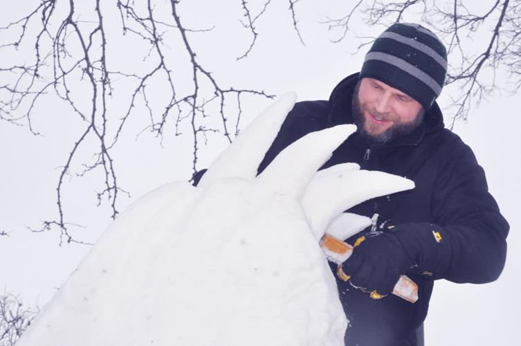 Stan Bovid, member of Michigan team "The Three Amigos" works on a snow sculpture