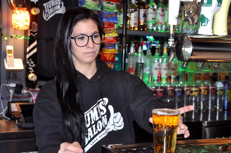 Kirsten Janikowski, Thumbs Up Saloon employee, prepares to serve a drink during a recent shift