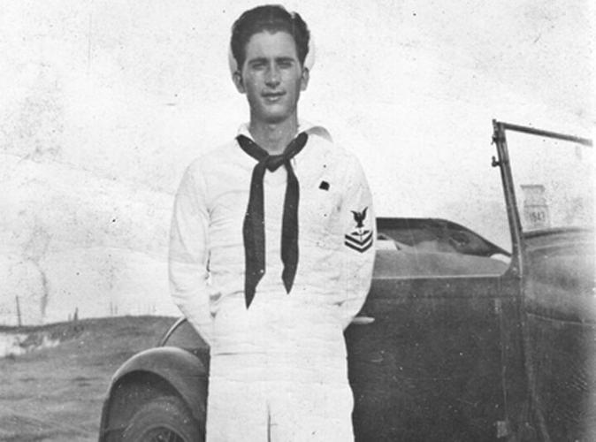 Lee Hayles poses with a Ford Roadster during his time in the U.S. Navy