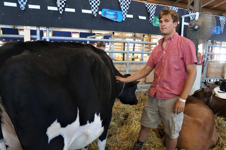 Owen Chelminiak exhibiting a Black-and-White Holstein at the 2022 Wisconsin State Fair