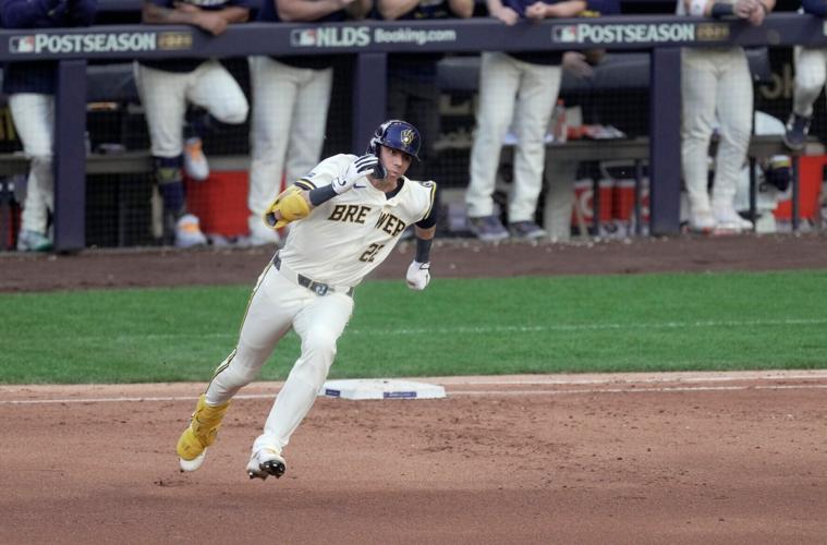 Milwaukee Brewers designated hitter Christian Yelich (22) bonds first base after hitting a double during the fifth inning of