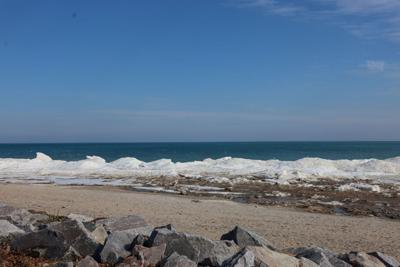 Snow melts on the Wind Point lakeshore during mid-February warm-up